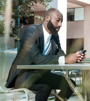 Professional checking his phone at the office