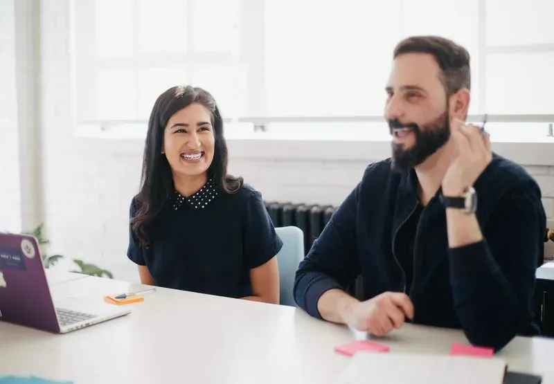 Colleagues smiling during a meeting