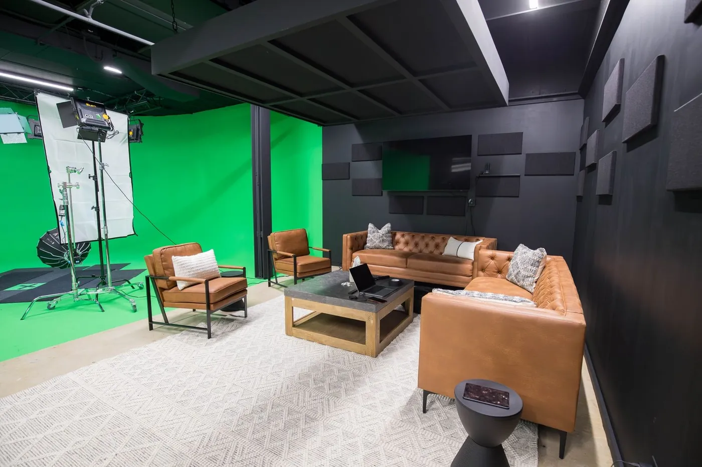 Lounge set with leather sofas beside the green screen