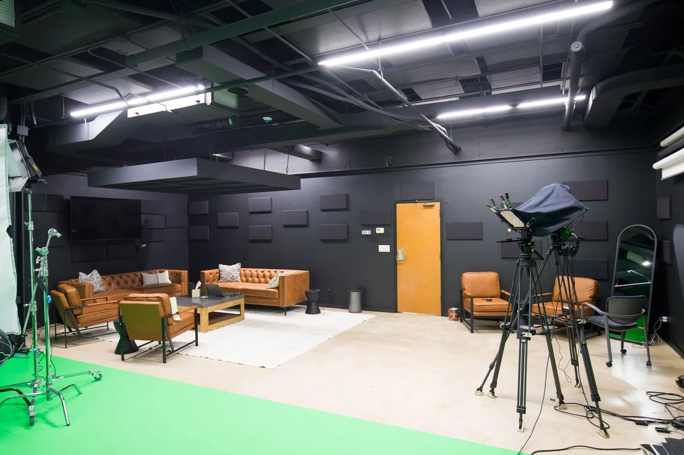 Studio floor with camera, lighting and seating area